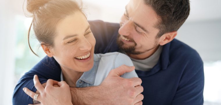 Cheerful romantic couple of lovers cuddling